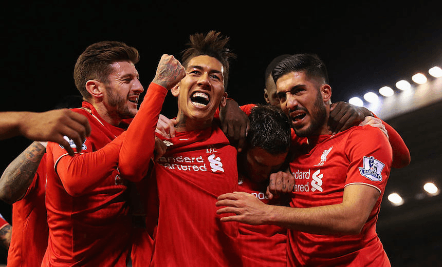 Liverpool FC’s James Milner is congratulated by Adam Lallana, Roberto Firmino and Emre Can after he scores their first goal from a penalty during the Barclays Premier League match between Liverpool and Swansea City at Anfield on November 29, 2015. (Photo by Alex Livesey/Getty Images) 
