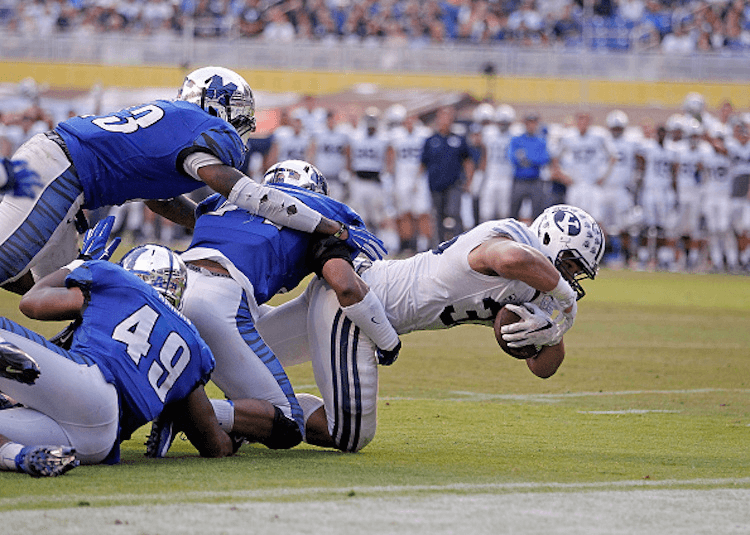 Paul Lasike #33 of the Brigham Young Cougars reaches to score a touchdown against the Memphis Tigers (Photo by Rob Foldy/Getty Images)