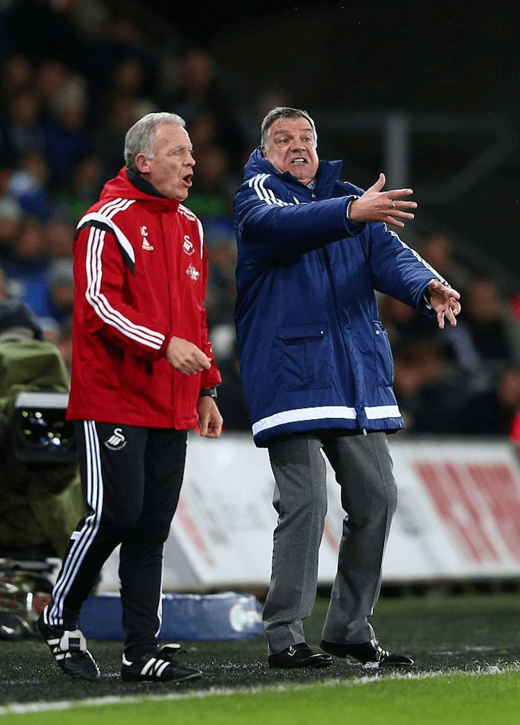 Swansea caretaker manager Alan Curtis (three stripe trackies and football boots) and Sunderland manager Sam Allardyce (suit pants and Hush Puppies).  (Photo by Michael Steele/Getty Images)