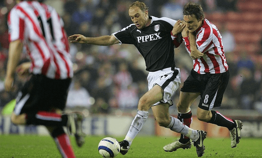 SUNDERLAND, UNITED KINGDOM – MAY 04: Simon Elliott of Fulham is held back by Dean Whitehead of Sunderland  during the Barclays Premiership match between Sunderland and Fulham at The Stadium of Light on May 4, 2006 in Sunderland, England.  (Photo by Laurence Griffiths/Getty Images) 
