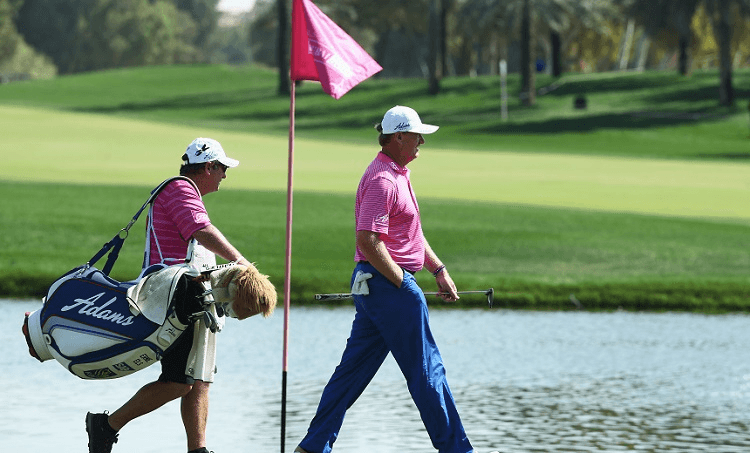 A CADDY LADEN DOWN BY GOLF CLUBS AND INJUSTICE