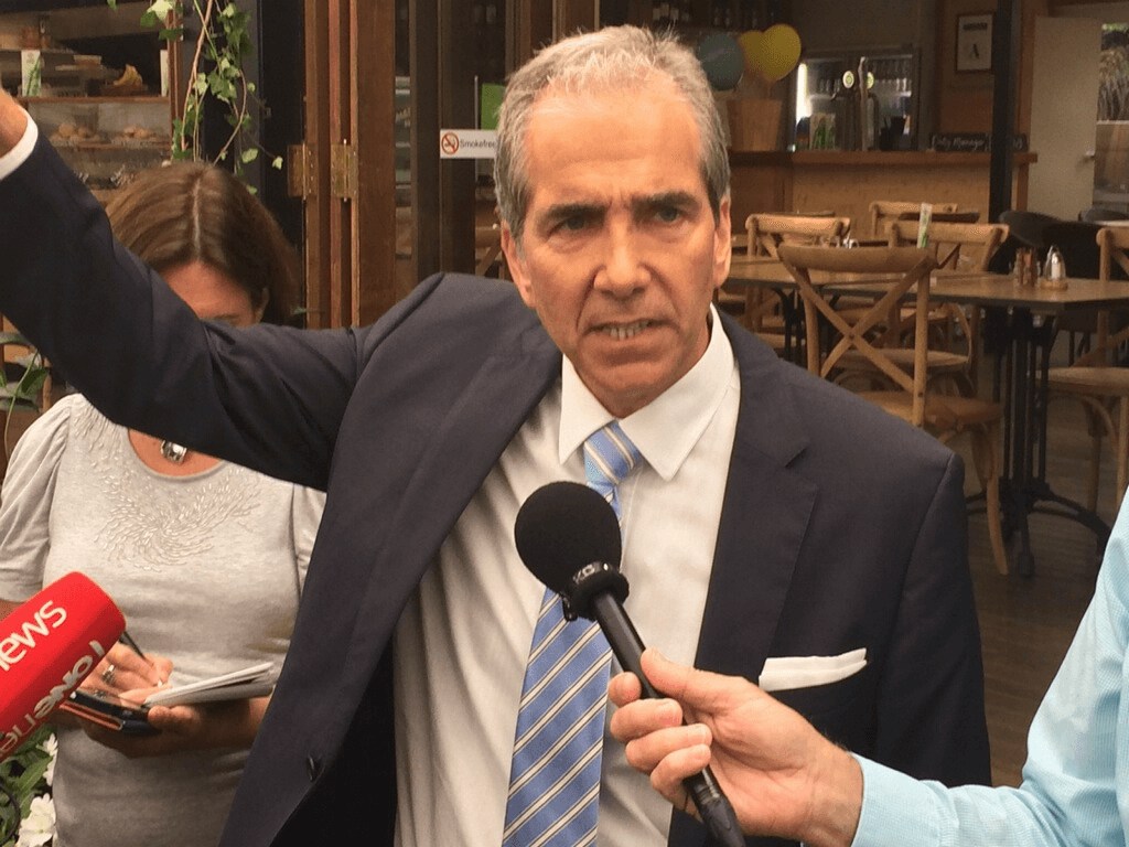 John Palino holds aloft his hat, before throwing it into the ring. Photograph: Tim Murphy