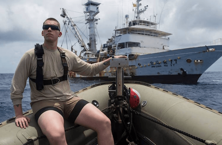 US Navy technician Cosmo Arnold approaching the Chinese purse seiner Jin Liao Yu 77 off Nauru last month. (US Navy photo by Mass Communication Specialist 3rd Class Emiline L M Senn) 
