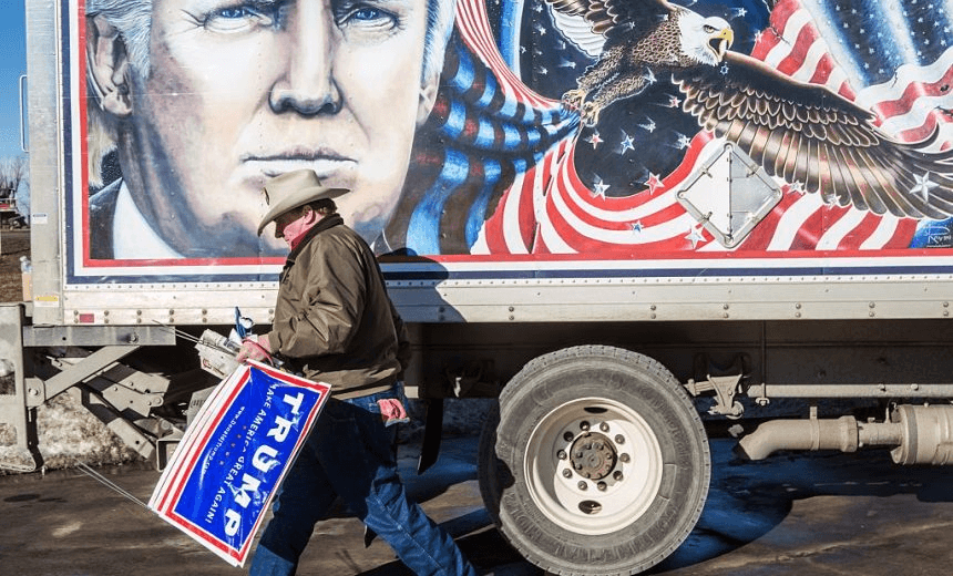 DES MOINES, IA – JANUARY 28: Kraig Moss, a supporter of Republican presidential candidate Donald Trump, outside a truck with a Trump painting in which he is touring Iowa on January 28, 2016 in Des Moines, Iowa. The Democratic and Republican Iowa Caucuses, the first step in nominating a presidential candidate from each party, will take place on February 1. (Photo by Brendan Hoffman/Getty Images) 

