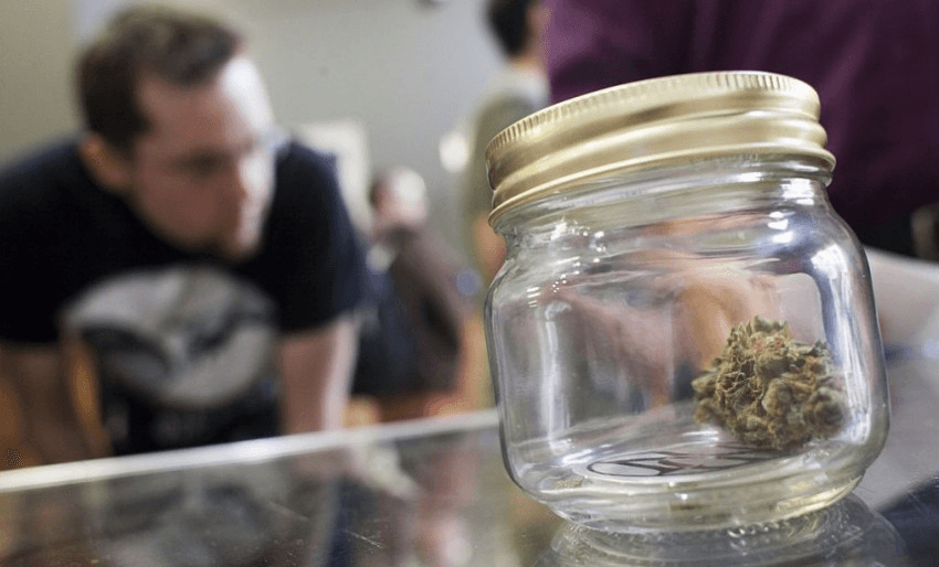 A customer (not Don Brash) inspects the wares s shop for marijuana at Top Shelf Cannabis, a retail marijuana store, on July 8, 2014 in Bellingham, Washington. Top Shelf Cannabis was the first retail marijuana store to open today in Washington state, nearly a year and a half after the state's voters chose to legalize marijuana. (Photo by David Ryder/Getty Images)