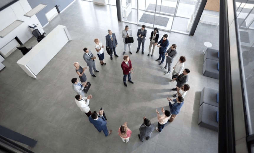 Top view of satisfied team clapping hands with manager in centre of circle