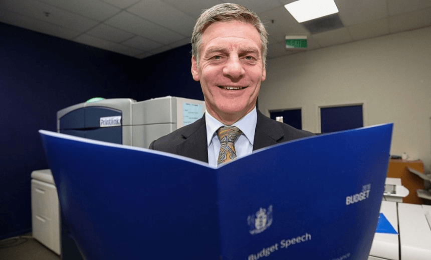 Bill English poses with a copy of his budget speech during the printing of the budget on May 24, 2016. (Photo by Hagen Hopkins/Getty Images) 
