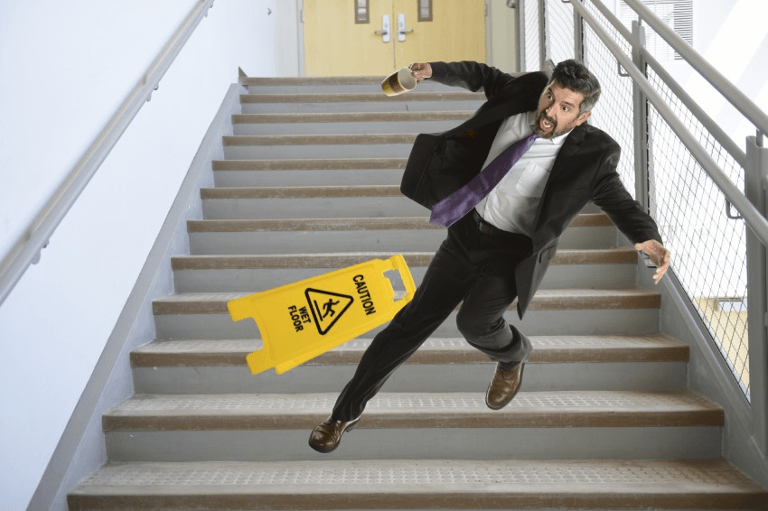 Mature Hispanic businessman falling down the stairs