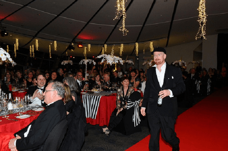 JARROD GILBERT, WINNER OF THE PEOPLE’S CHOICE AWARD IN 2014, MODELS A MATE’S TUX AND A BOTTLE OF PISS 