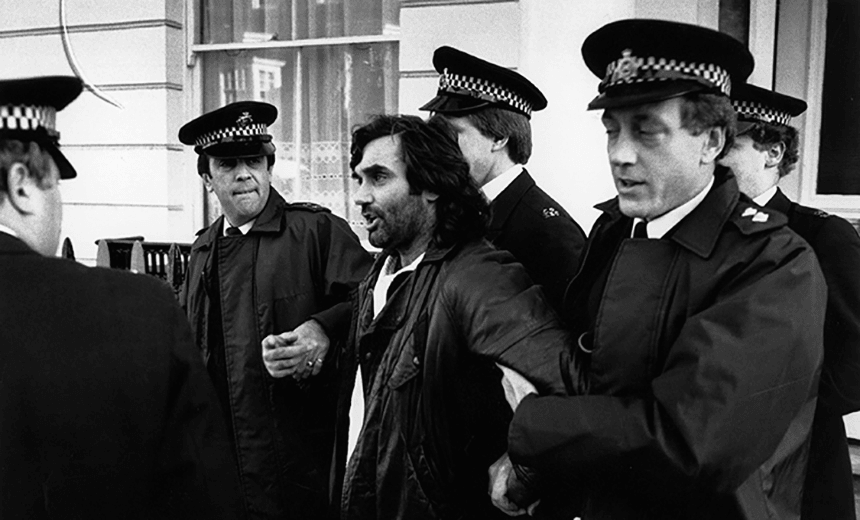 Irish footballer George Best is led away by policemen. He was later accused of drunk driving and assaulting a police officer.    (Photo by Express Newspapers/Getty Images) 
