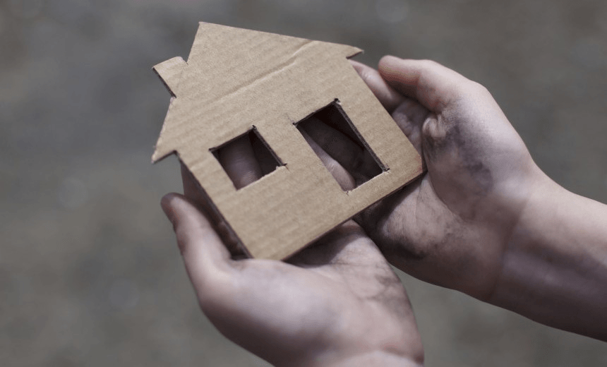 homeless boy holding a cardboard house, dirty hand 
