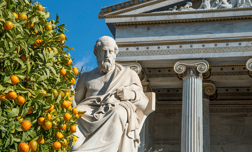 Statue of Plato and an orange tree at the Academy of Athens in Greece 
