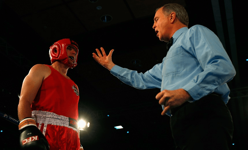 MARK WATSON, RED TRUNKS, IS REMONSTRATED WITH BY A CROTCHETY ELDERLY GENTLEMAN. PHOTO / GETTY 
