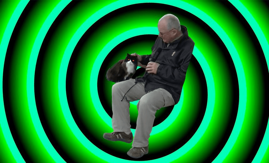 GEORGE WOOD CONSULTS HIS FELINE OVERLORD. PHOTO: JOSE BARBOSA 
