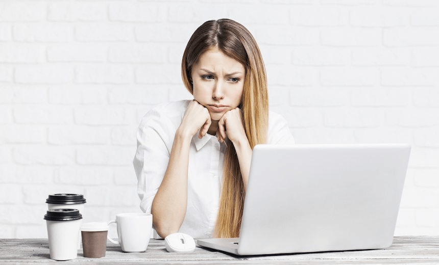 Stressed business woman working on a laptop