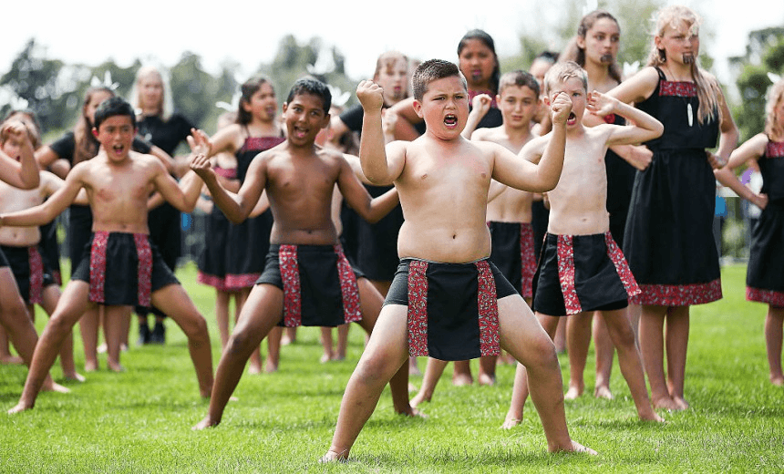 Children perform a haka for Prince Charles, Prince of Wales and Camilla, Duchess of Cornwall during the ‘Tea With Taranaki’ event at Brooklands Park on November 9, 2015 (Photo by Hagen Hopkins/Getty Images) 
