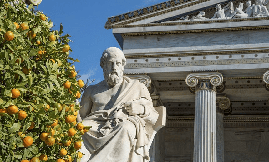 Statue of Plato and an orange tree at the Academy of Athens in Greece 
