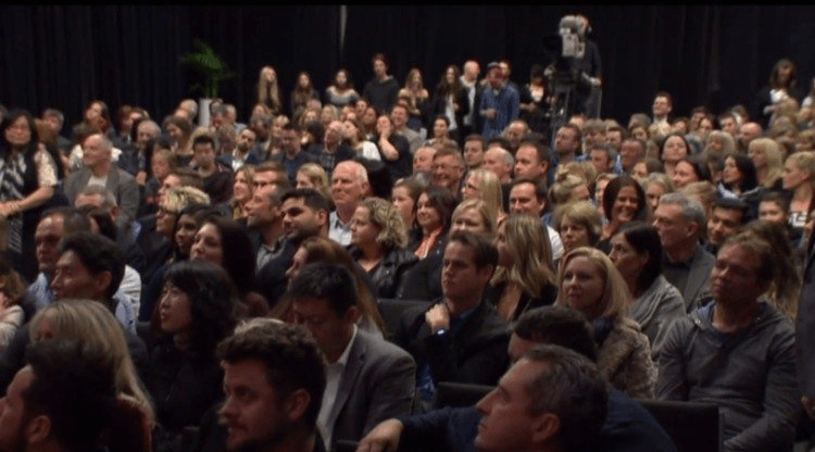 A room filled with people who can afford a house in Auckland
