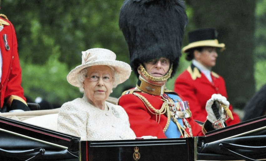 London, England, UK - June 13 2015: Queen Elizabeth II and Prince Phillip Duke of Edinburgh appear in open horse drawn carriage during Trooping the Colour ceremony, on June 13, 2015 in London, England, UK