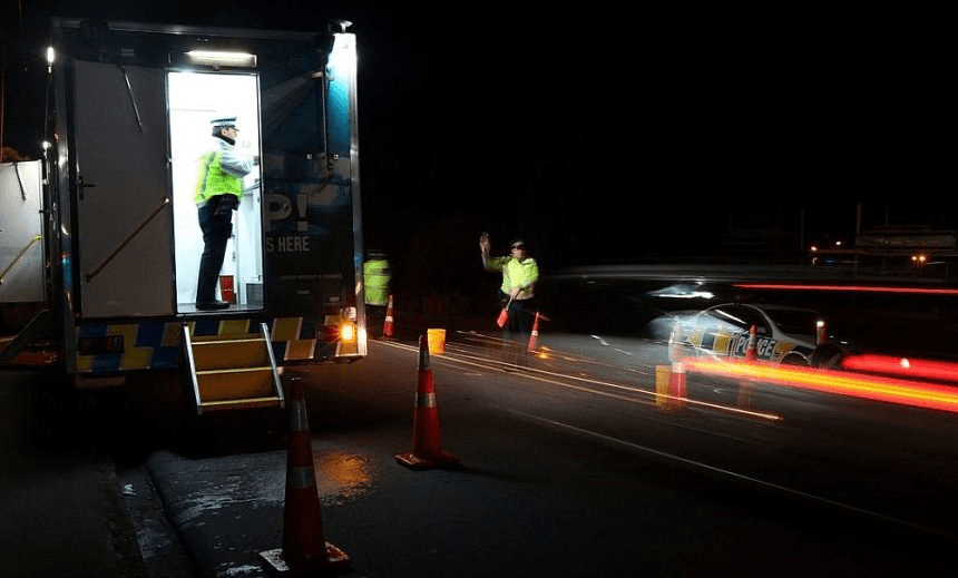 AUCKLAND, NEW ZEALAND – JULY 30: A police officer stops a motorist at a drink driving check point in Penrose on July 30, 2010 in Auckland, New Zealand. The government is implementing a zero-tolerance policy for drivers under 20 and repeat drink-drivers, but will conduct more research before deciding whether to lower the adult alcohol limit from 0.08g of alcohol per 100ml to 0.05g. (Photo by Sandra Mu/Getty Images)