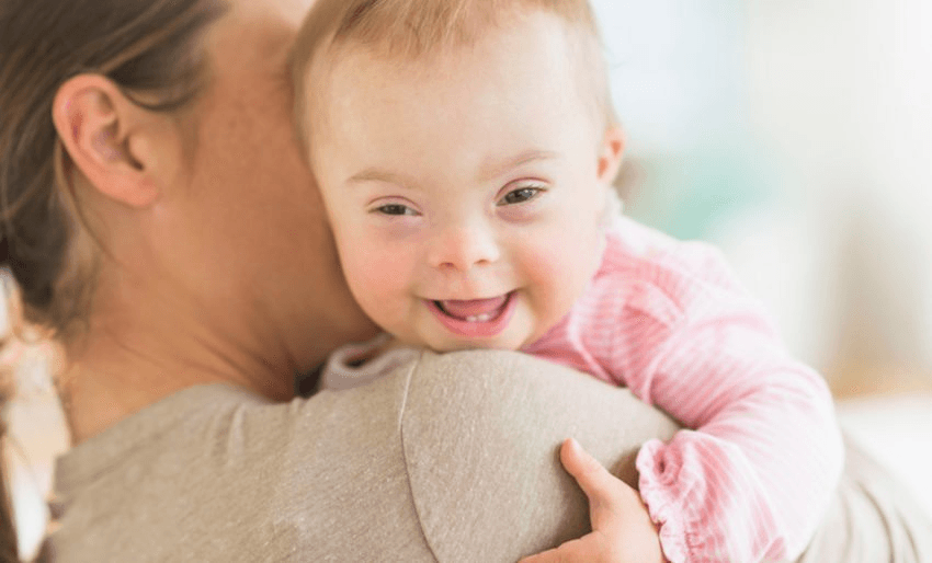 A mother holding a baby girl with Down Syndrome. Photo: JGI/Tom Grill