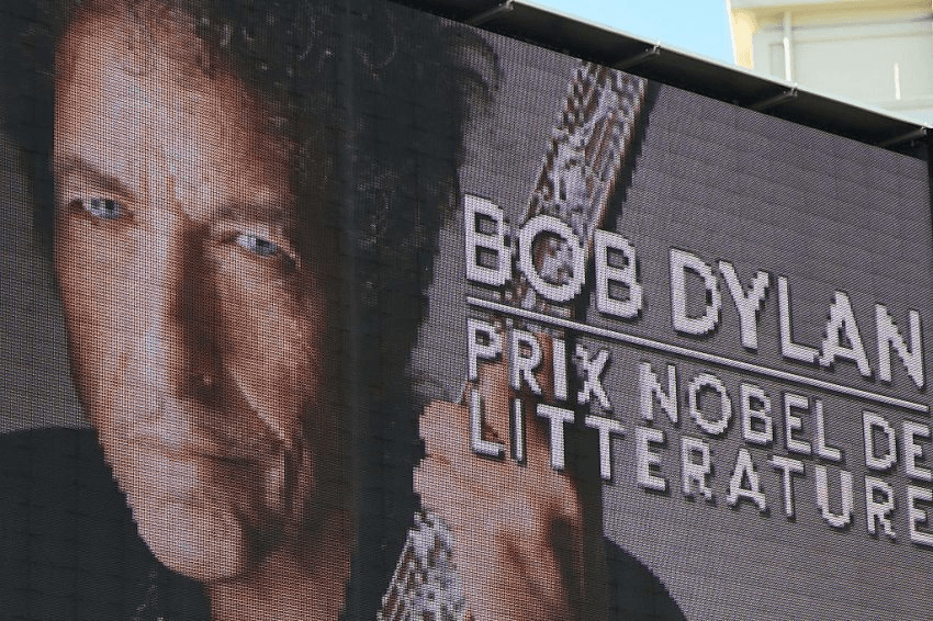 A board displays a picture of US musician Bob Dylan with the inscription "Bob Dylan, Nobel Prize in Literature" before the European Champions Cup rugby union match between Toulon and Saracens at the Mayol stadium in Toulon on October 15, 2016. / AFP / BORIS HORVAT (Photo credit should read BORIS HORVAT/AFP/Getty Images)