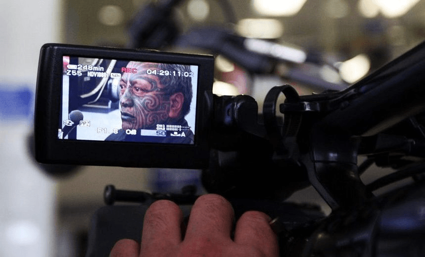 Tame Iti is filmed as he speaks to the media after being discharged at the Auckland District Court on firearm charges on October 17, 2008 in Auckland, New Zealand. Seventeen of the 18 people charged in a police surveillance operation in the Ureweras last October have been committed to trial on firearm charges. (Photo by Hannah Peters/Getty Images)