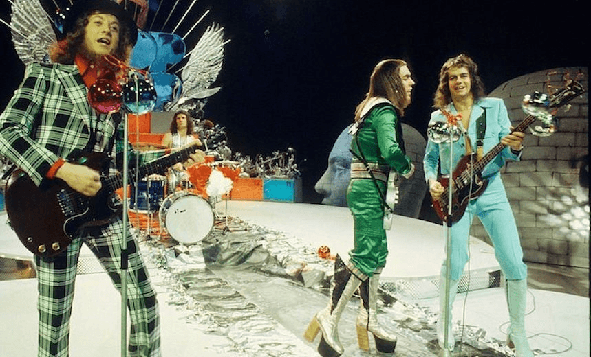 (L-R) Noddy Holder, Don Powell, Dave Hill and Jim Lea of Slade perform on a Christmas TV show in December 1973 in Hilversum, netherlands. (Photo by Gijsbert Hanekroot/Redferns) 
