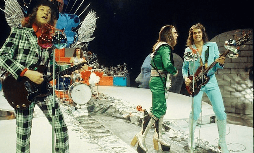 (L-R) Noddy Holder, Don Powell, Dave Hill and Jim Lea of Slade perform on a Christmas TV show in December 1973 in Hilversum, netherlands. (Photo by Gijsbert Hanekroot/Redferns)
