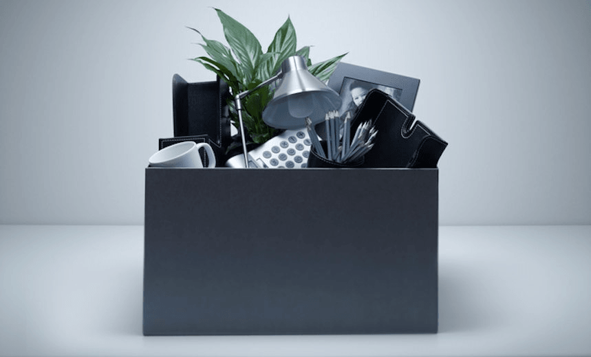 Box packed with desk objects