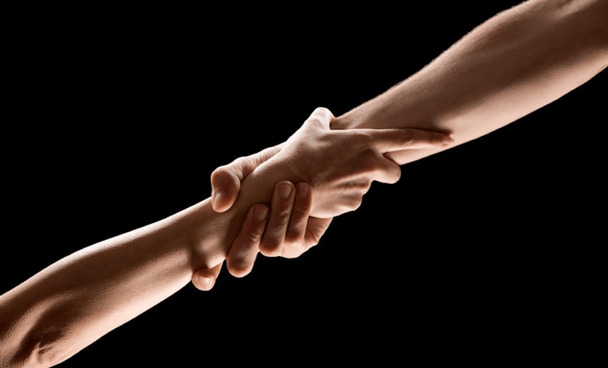 Man and woman engage each other at the wrist 
