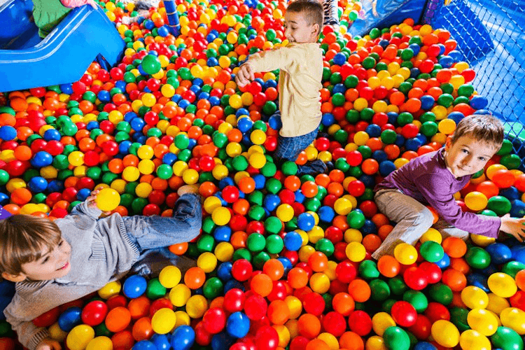 Cute little boys playing in the ball pool.