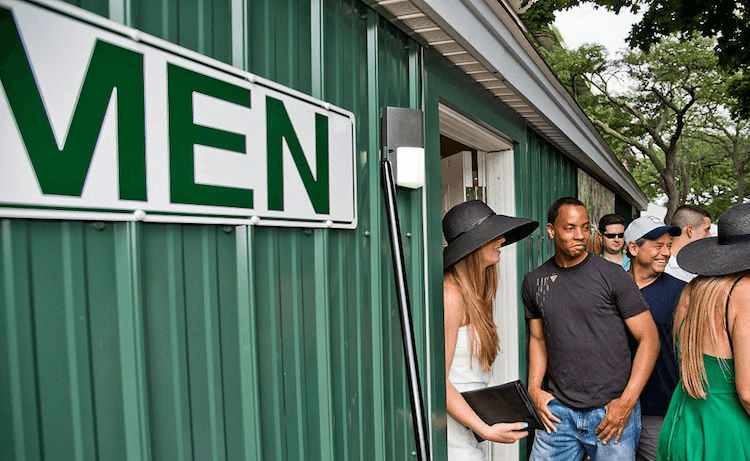 Men watch as women walk out of the men's toilet to skip the longer queue for The Ladies on Belmont Stakes Day 2016, in Elmont, New York. (Photo: Scott Serio/Eclipse Sportswire/Getty Images)