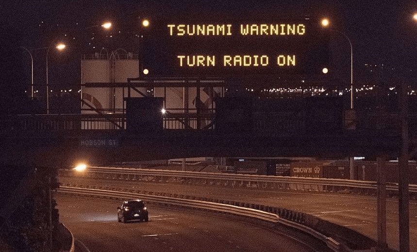 A tsunami warning alert is seen on a notice board above State Highway 1 in Wellington early on November 14, 2016 following an earthquake centred some 90 kilometres (57 miles) north of New Zealand’s South Island city of Christchurch. 
A powerful 7.8 magnitude earthquake rocked New Zealand early November 14, the US Geological Survey said, prompting a tsunami warning and knocking out power and phone services in many parts of the country.  / AFP / Marty Melville        (Photo credit should read MARTY MELVILLE/AFP/Getty Images) 
