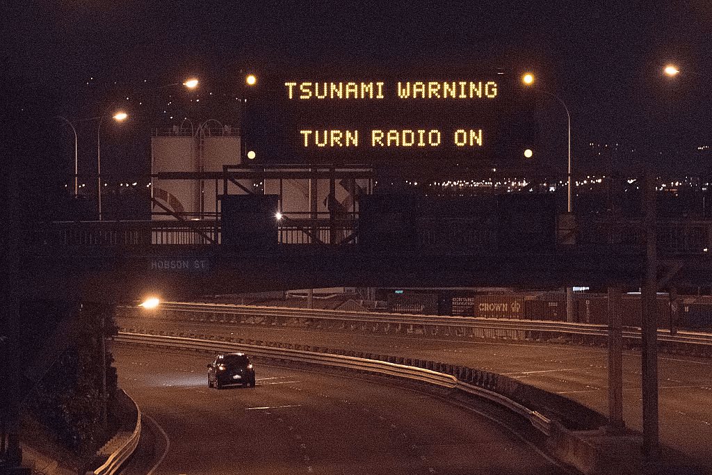 A tsunami warning alert is seen on a notice board above State Highway 1 in Wellington early on November 14, 2016 following an earthquake centred some 90 kilometres (57 miles) north of New Zealand's South Island city of Christchurch. A powerful 7.8 magnitude earthquake rocked New Zealand early November 14, the US Geological Survey said, prompting a tsunami warning and knocking out power and phone services in many parts of the country. / AFP / Marty Melville (Photo credit should read MARTY MELVILLE/AFP/Getty Images)