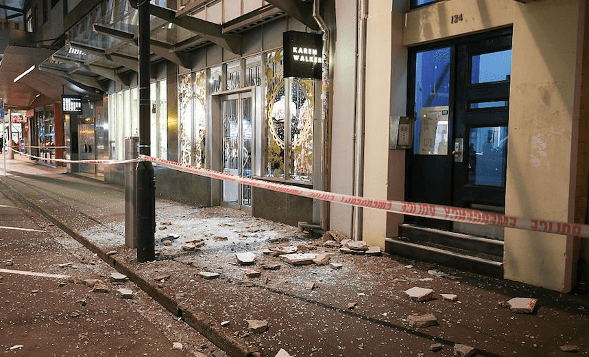 Glass and rubble covers the footpath on Wakefield Street after the November 14 earthquake. Photo by Hagen Hopkins/Getty Images 
