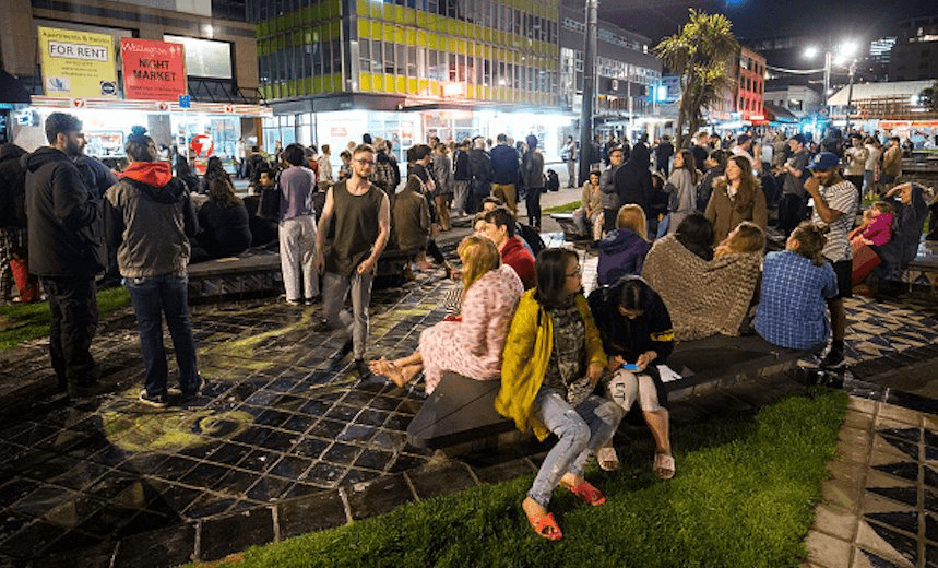 People wait in Te Aro Park, Wellington, after being evacuated from nearby buildings following the earthquake. (Photo by Hagen Hopkins/Getty Images) 

