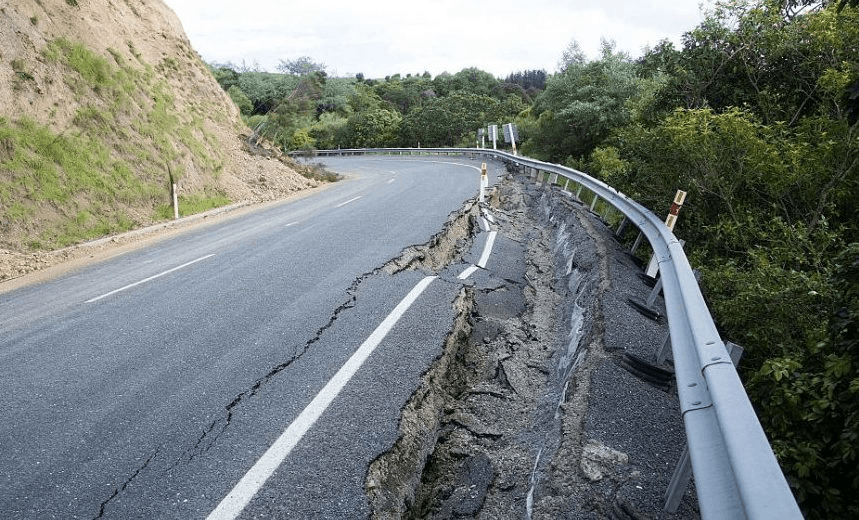 Earthquake damage to State Highway 1 is seen south of Kaikoura on November 16, 2016. 
Rescue efforts after a devastating earthquake in New Zealand intensified on November 16 as a fleet of international warships began arriving in the disaster zone. / AFP / Marty MELVILLE        (Photo credit should read MARTY MELVILLE/AFP/Getty Images) 
