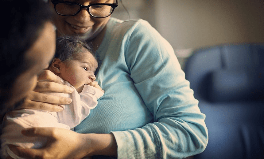 Mum holding newborn at hospital