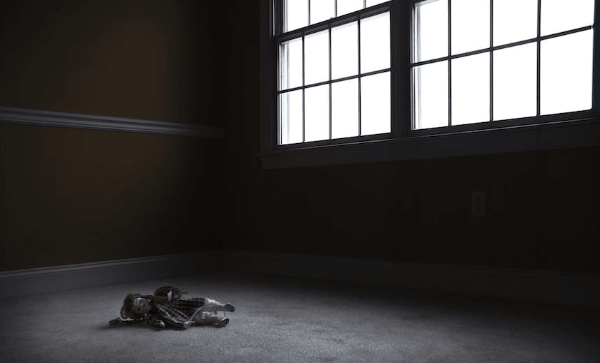 Old Doll Sitting in Empty, Dark Room
