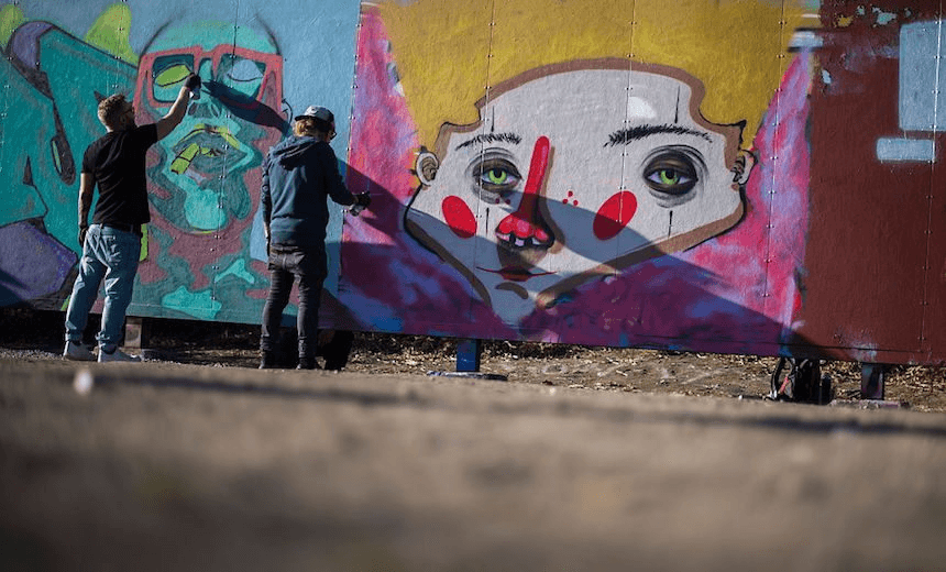 People spray color on a special made wall placed for Graffiti artists on October 2, 2016 at Tantolunden park in Sodermalm, Stockholm. 
The wall in Tantolunden is a total of 36 meters long and serves as a constantly changing work of art that people get to legally paint on.  / AFP / JONATHAN NACKSTRAND        (Photo credit should read JONATHAN NACKSTRAND/AFP/Getty Images) 
