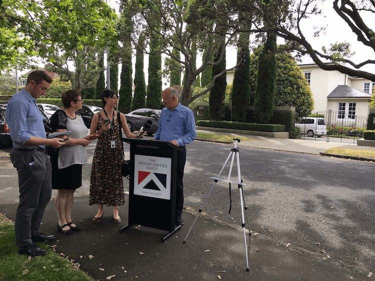 Reporters grill Morgan at the Opportunities Party policy launch event outside John Key's home.