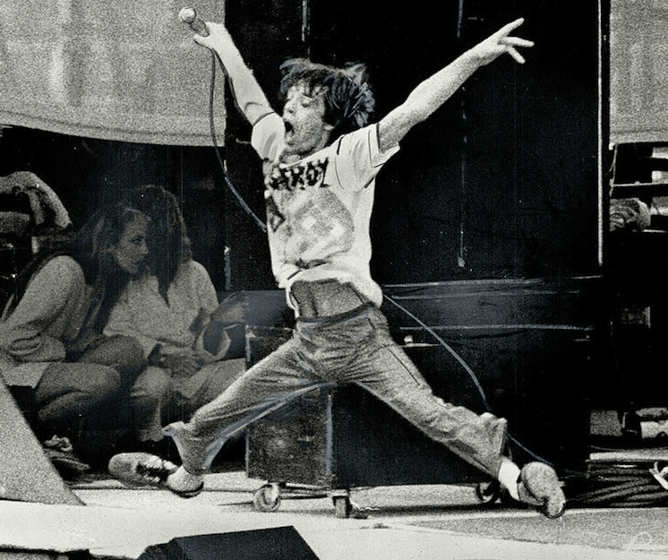 Mick Jagger with a Nazi swastika and the word Destroy on his T-shirt.