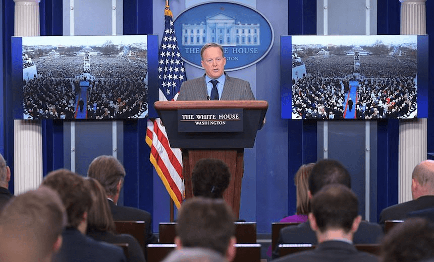 White House Press Secretary Sean Spicer delivers his first statement to the White House Press Core, flanked by photos of the Trump presidency, January 21, 2017. (Photo: MANDEL NGAN/AFP/Getty Images) 
