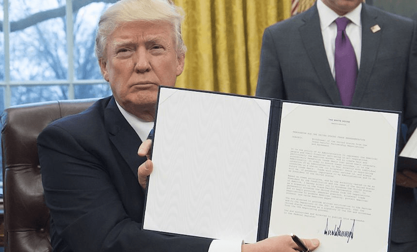 US President Donald Trump holds up an executive order withdrawing the US from the Trans-Pacific Partnership after signing it in the Oval Office of the White House in Washington, DC, January 23, 2017. 
(Photo: SAUL LOEB/AFP/Getty Images) 
