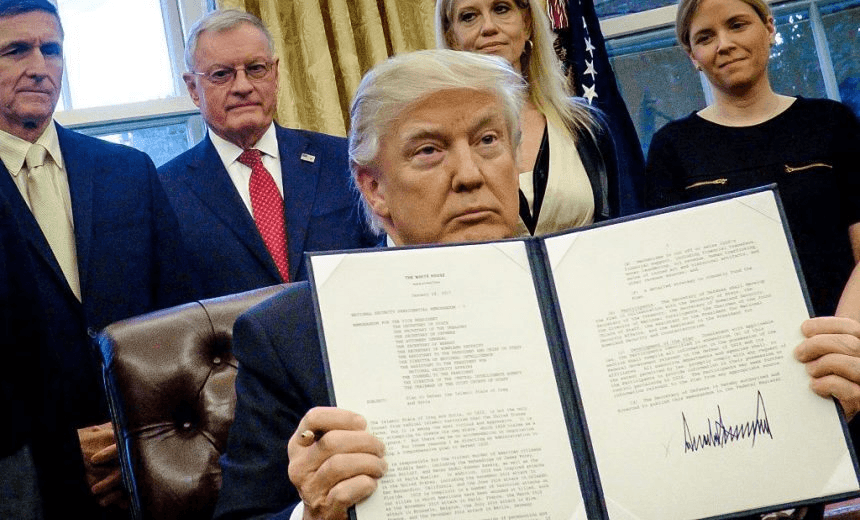 President Donald Trump holds up one of the executive actions that he signed in the Oval Office on January 28, 2017 in Washington, DC.  (Photo: Pete Marovich – Pool/Getty Images) 
