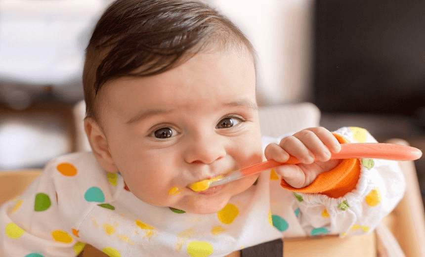 Baby boy eating pureed food