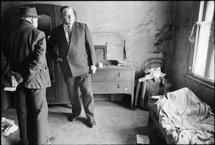Leader of the Opposition Norman Kirk visiting the home of a pensioner in Te Aro, Wellington. Photograph taken circa 6 October 1966 by an unidentified Evening Post staff photographer. (The Dominion Post Collection, Alexander Turnbull Library)