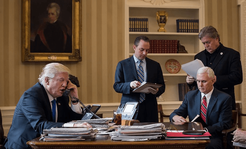 President Donald Trump speaks on the phone with Russian President Vladimir Putin in the Oval Office of the White House, January 28, 2017 in Washington, DC. Also pictured, from left, White House Chief of Staff Reince Priebus, Vice President Mike Pence, and White House Chief Strategist Steve Bannon.  (Photo by Drew Angerer/Getty Images) 
