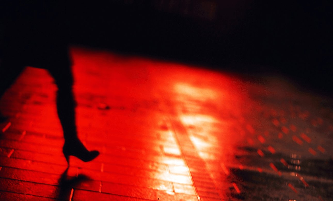 Woman Walking On Dark Street